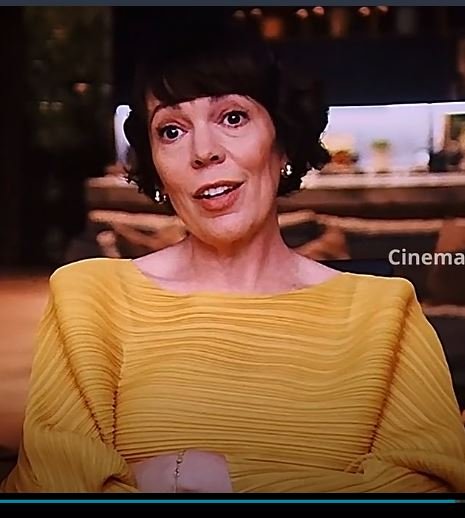 the roses olivia colman yellow top